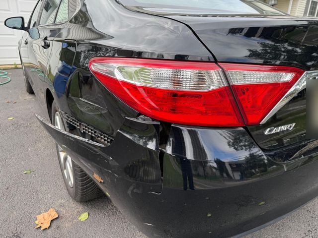 Rear left corner: bumper cover split below the taillight and pulled away