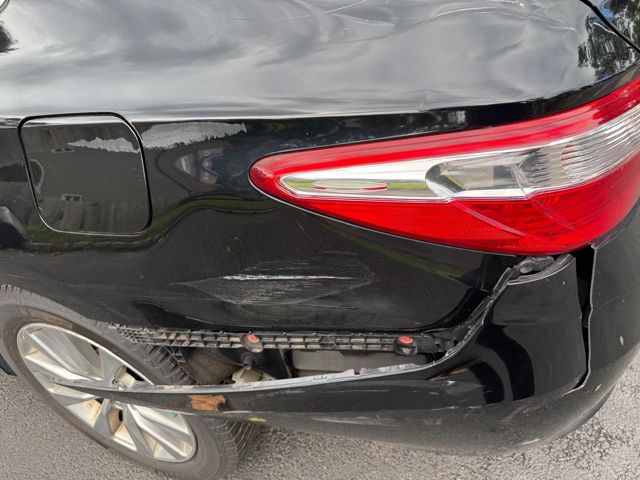 Scrapes on the quarter panel and exposed bumper retainer bracket
